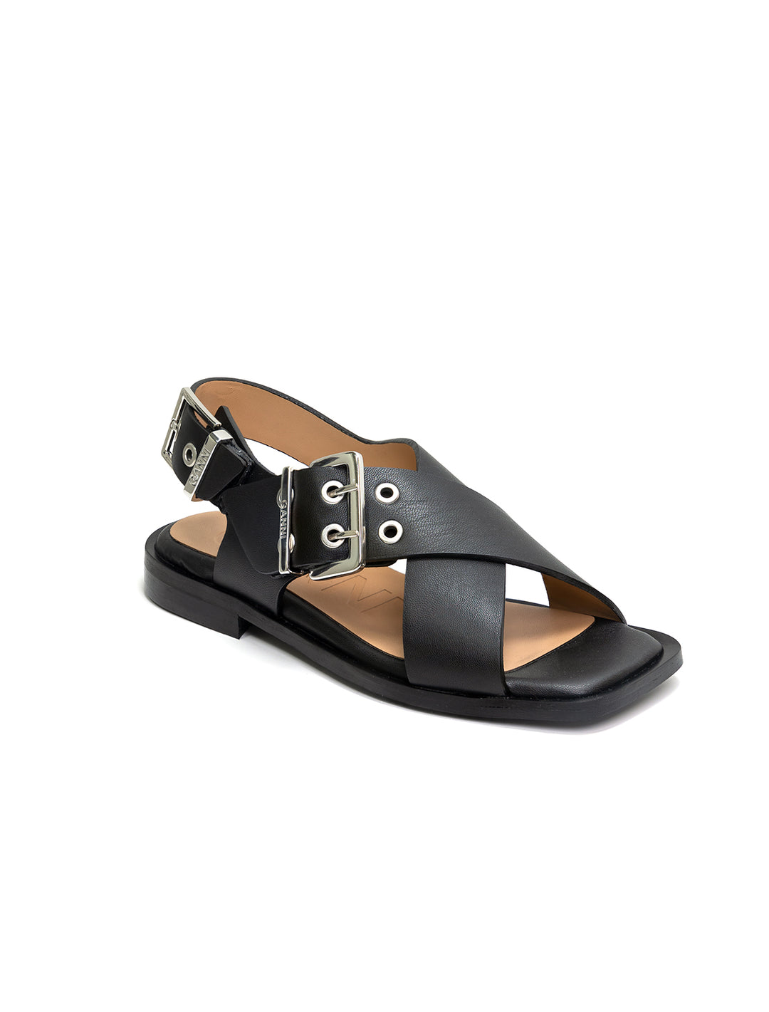 Front angle view of GANNI's black cross strap buckle sandals.