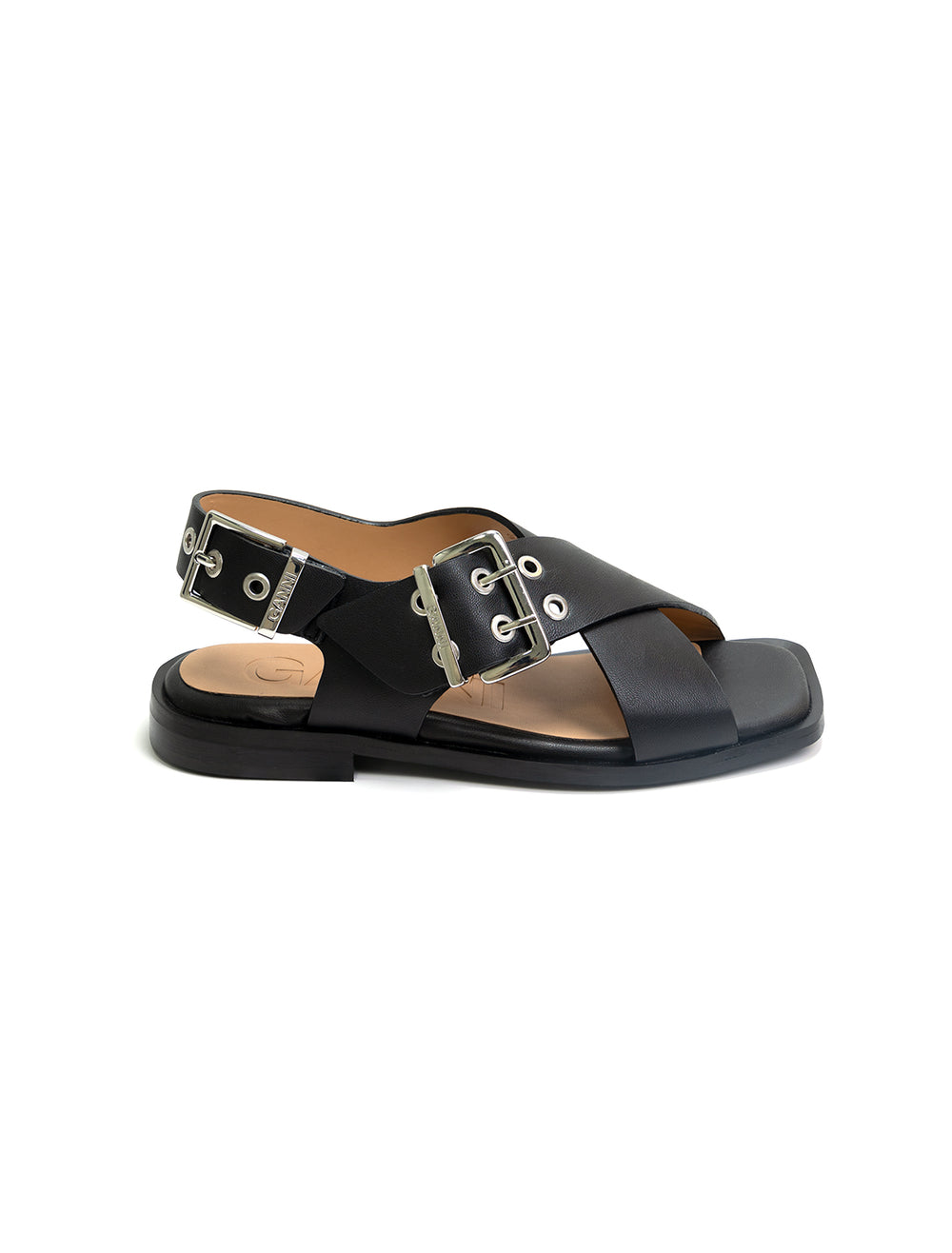 Side view of GANNI's black cross strap buckle sandals.
