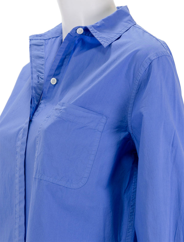 Close-up view of Alex Mill's belle shirt dress in french blue paper poplin.