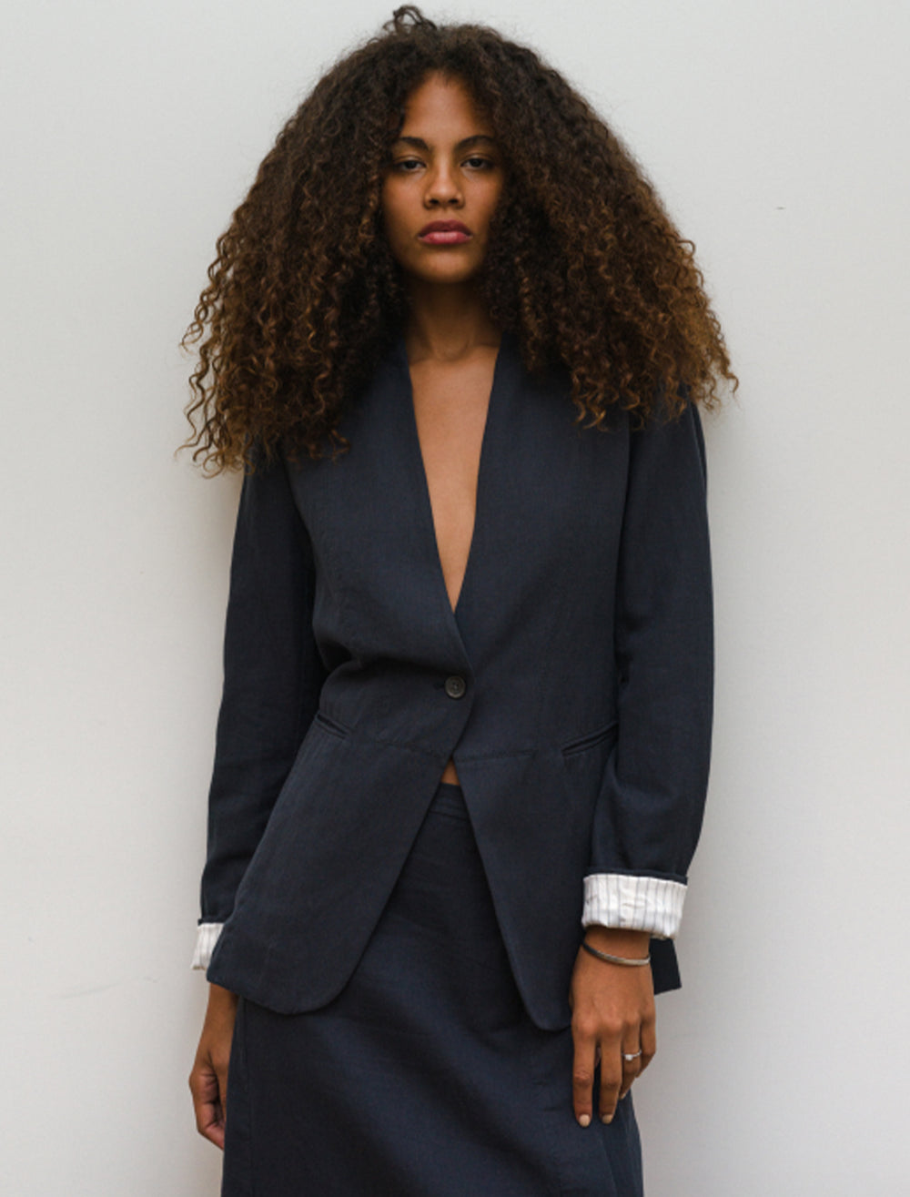 Model wearing Alex Mill's bib seam blazer in washed black.