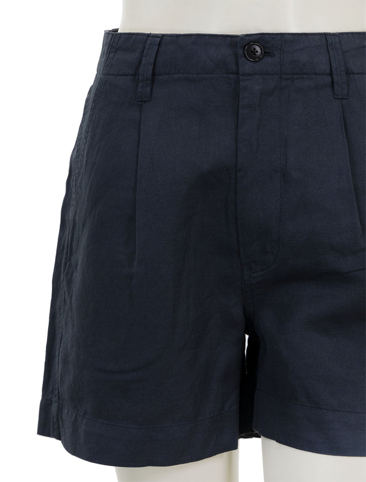 Close-up view of Alex Mill's pleated twill shorts in washed black.