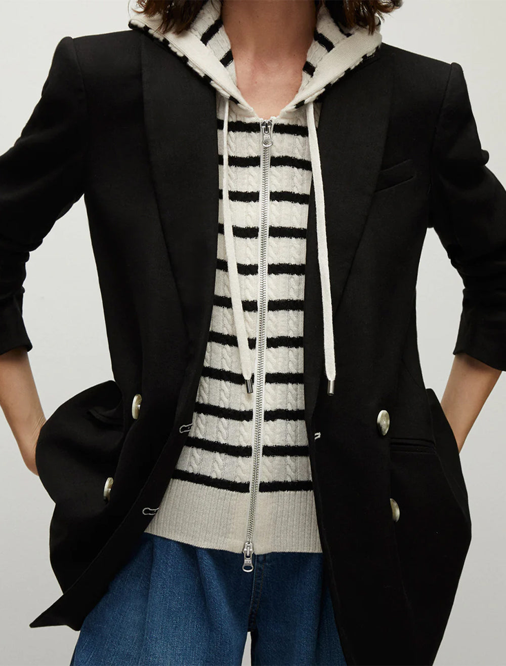 Model wearing Veronica Beard's bunny hoodie dickey in off white and black stripe.