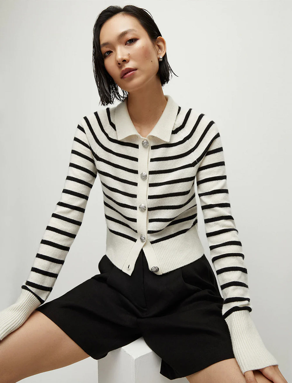 Model wearing Veronica Beard's cheshire cardigan in off-white and black stripe.