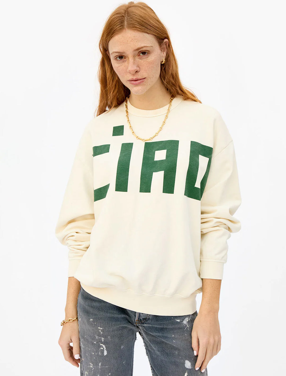 Model wearing Clare V.'s ciao oversized sweatshirt in cream and evergreen.