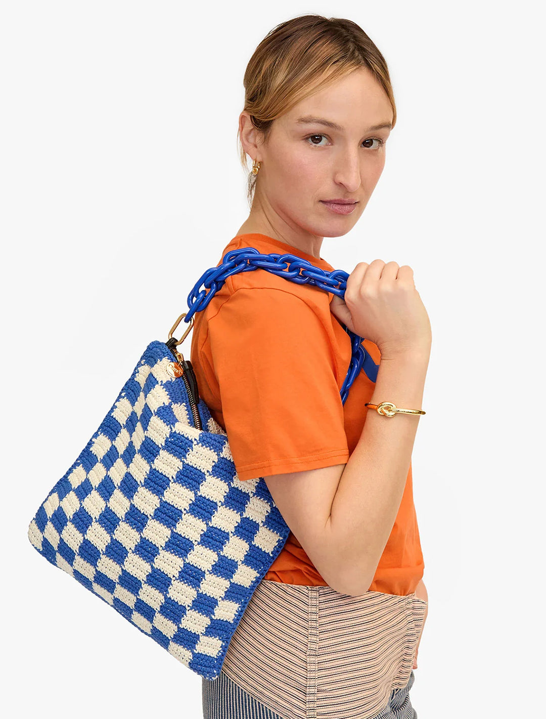 Model wearing shortie strap in cobalt resin attached to a bag.