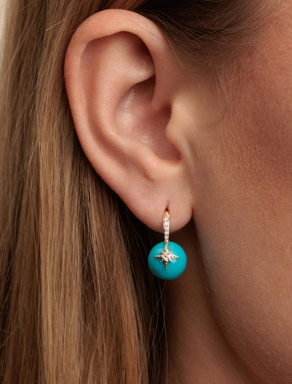 Model wearing Sydney Evan's turquoise pave starburst bead earrings.