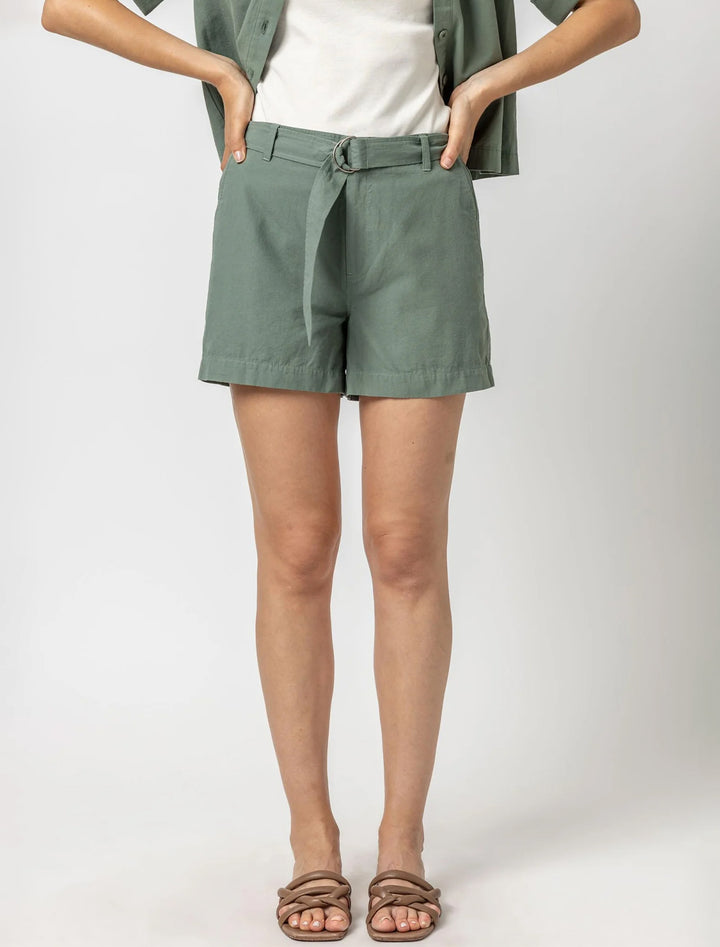 Model wearing Lilla P.'s belted canvas shorts in seagrass.