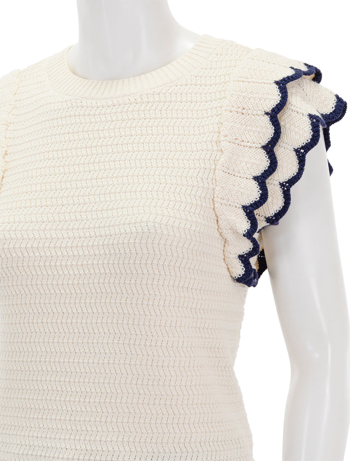 Close-up view of Lilla P.'s tipped sleeve crewneck sweater in ivory.