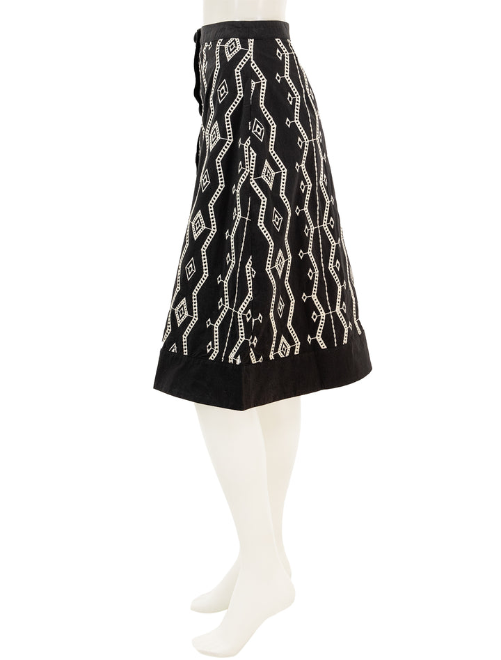 Side view of Suncoo Paris' first eyelet skirt in noir.