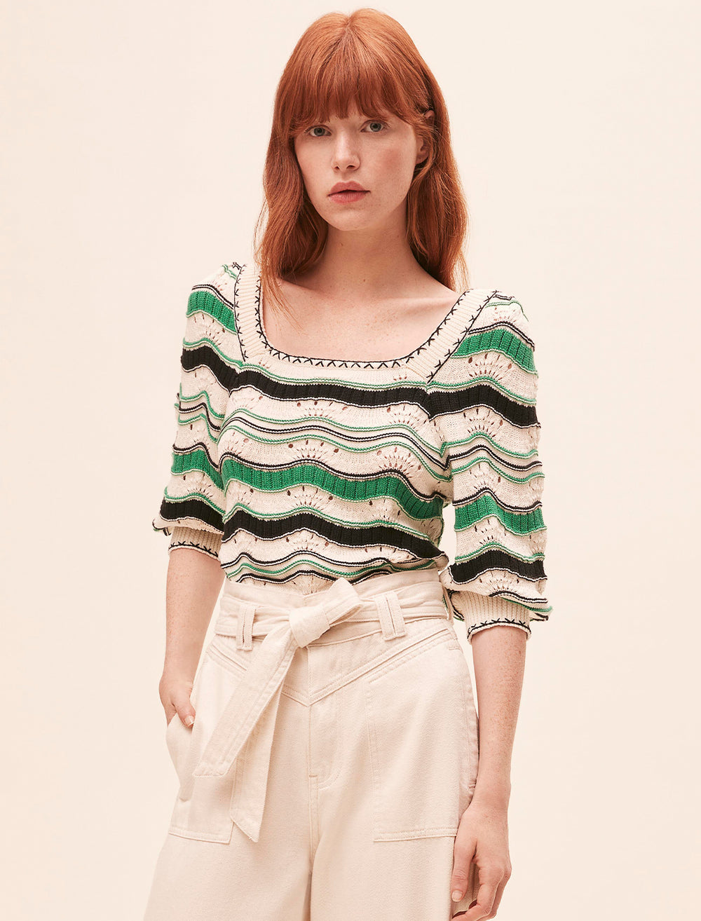 Model wearing Suncoo Paris' patrici sweater in vert multi stripe.