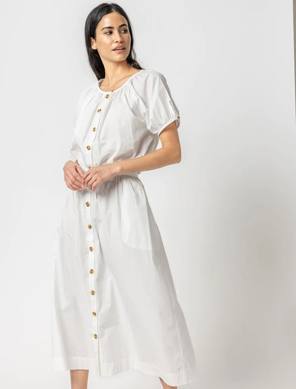 model wearing elastic hem button front top in white