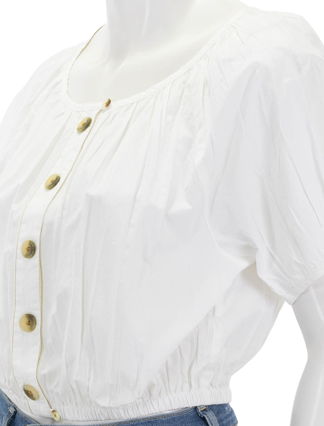 close up view of elastic hem button front top in white