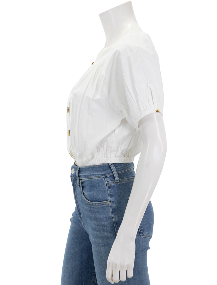 side view of elastic hem button front top in white