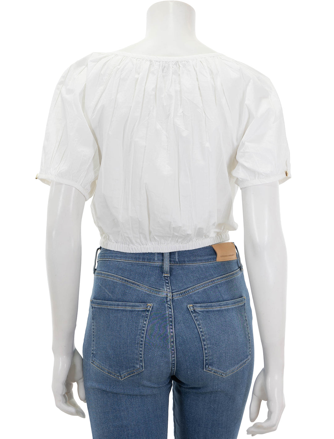back view of elastic hem button front top in white