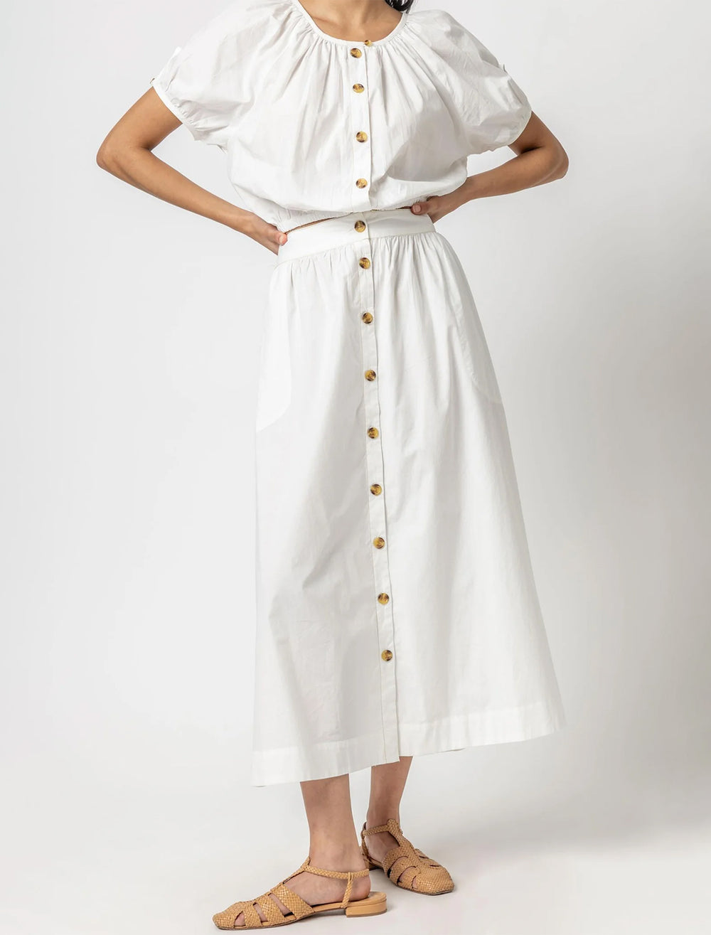 Model wearing Lilla P.'s button front long skirt in white.