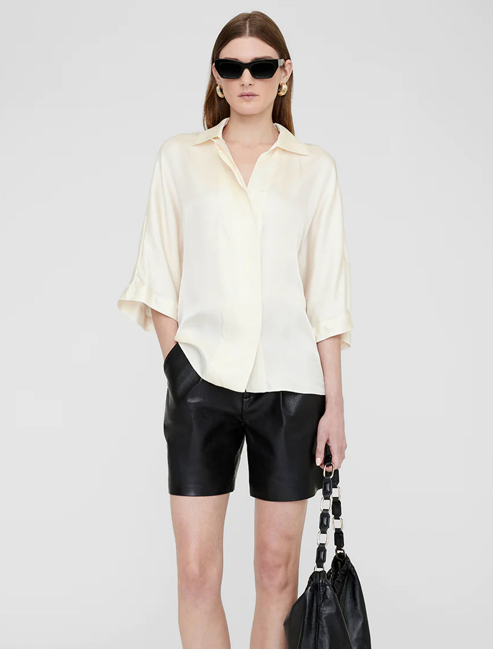 Model wearing Anine Bing's julia blouse in ivory.