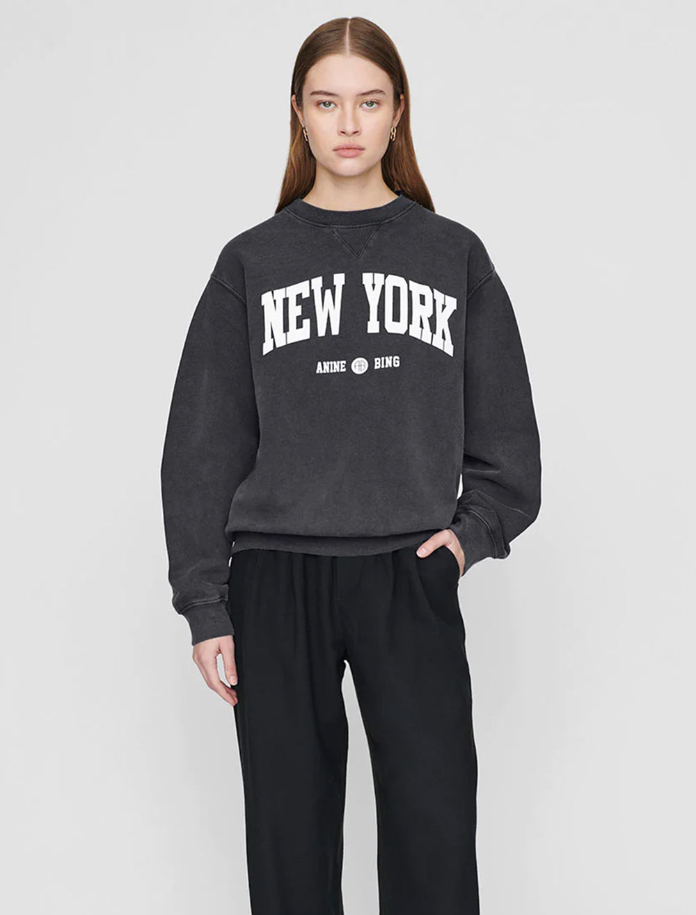 Model wearing Anine Bing's new york ramona sweatshirt in washed black.