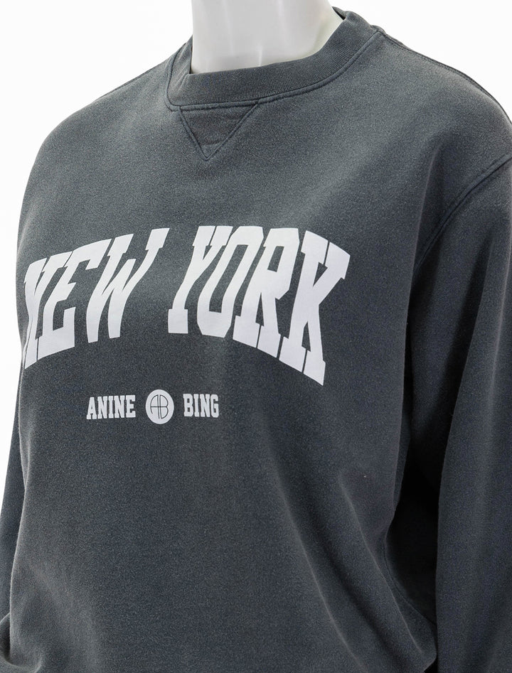 Close-up view of Anine Bing's new york ramona sweatshirt in washed black.