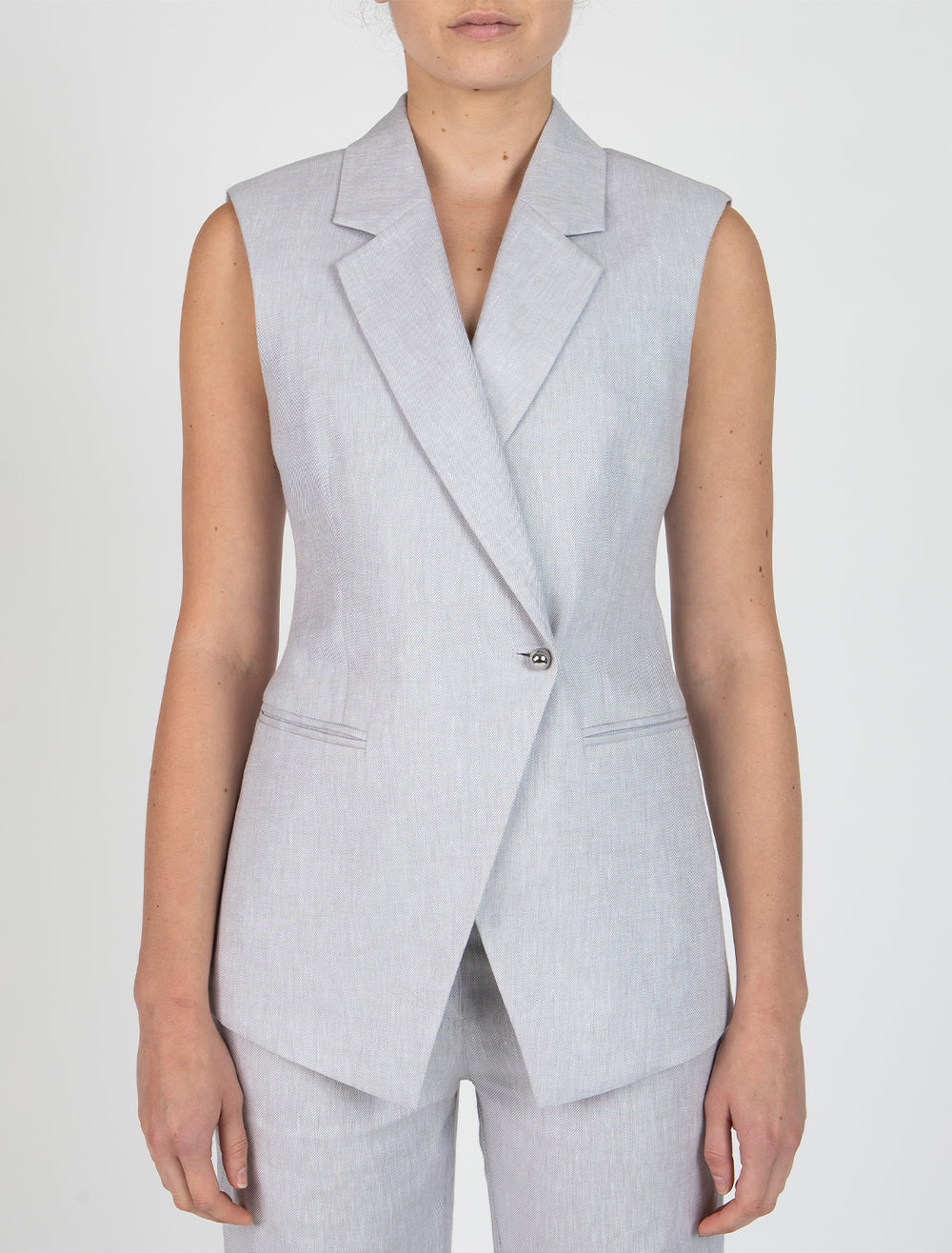 Model wearing Derek Lam 10 Crosby's taylor vest in pale grey.