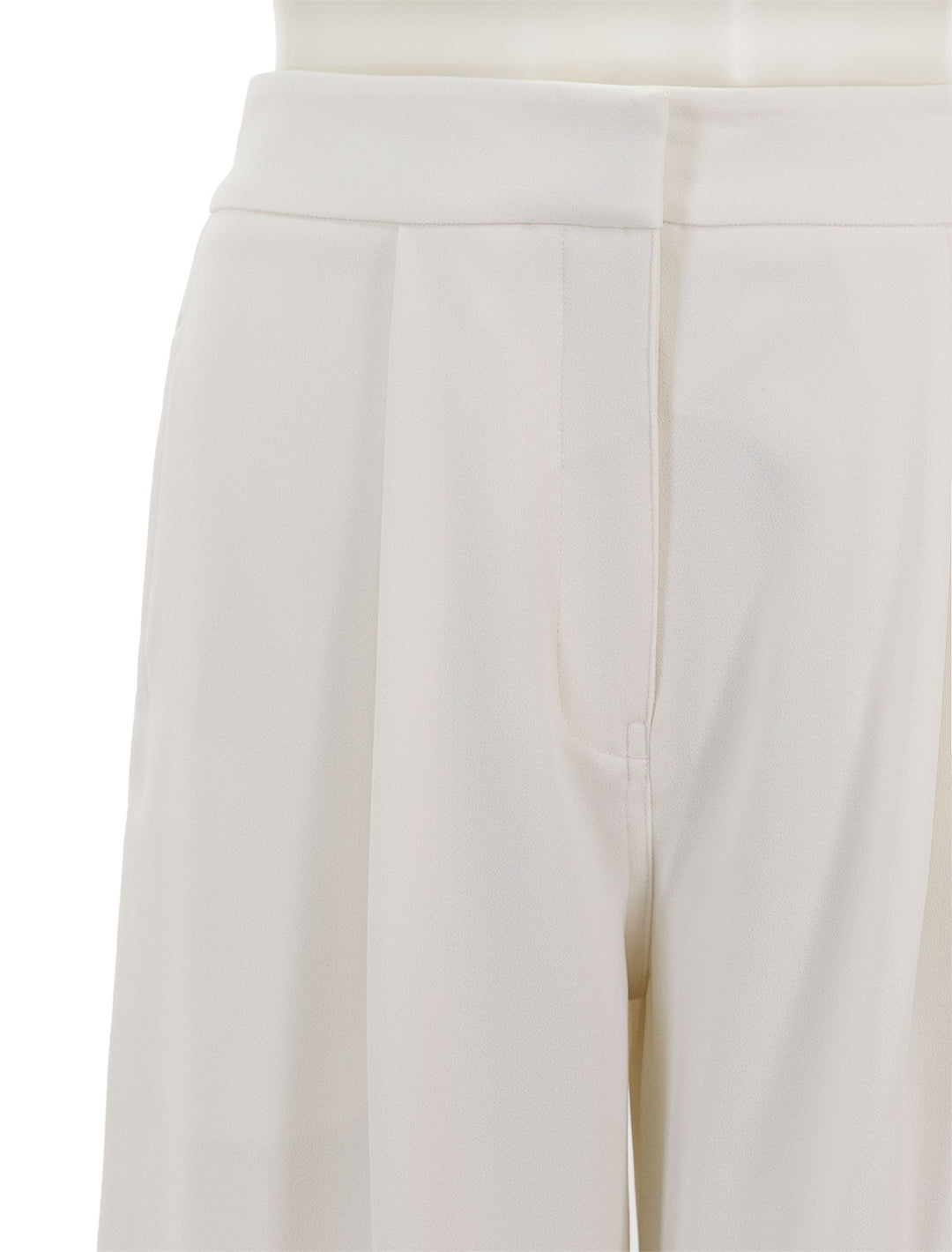 Close-up view of Saint Art's neve mid waisted wideleg trouser in ivory crepe.