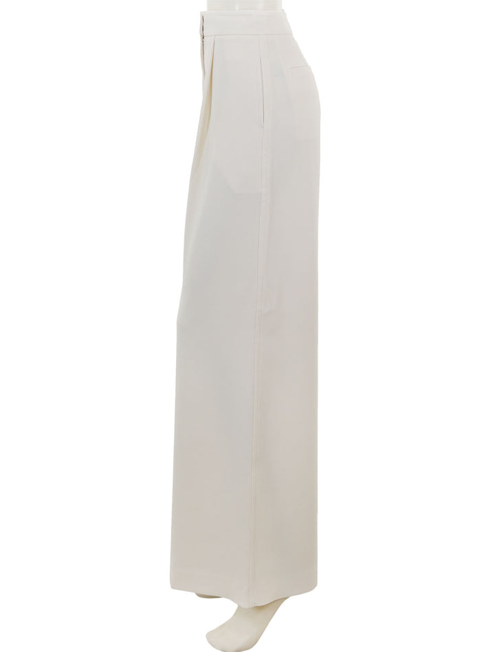 Side view of Saint Art's neve mid waisted wideleg trouser in ivory crepe.