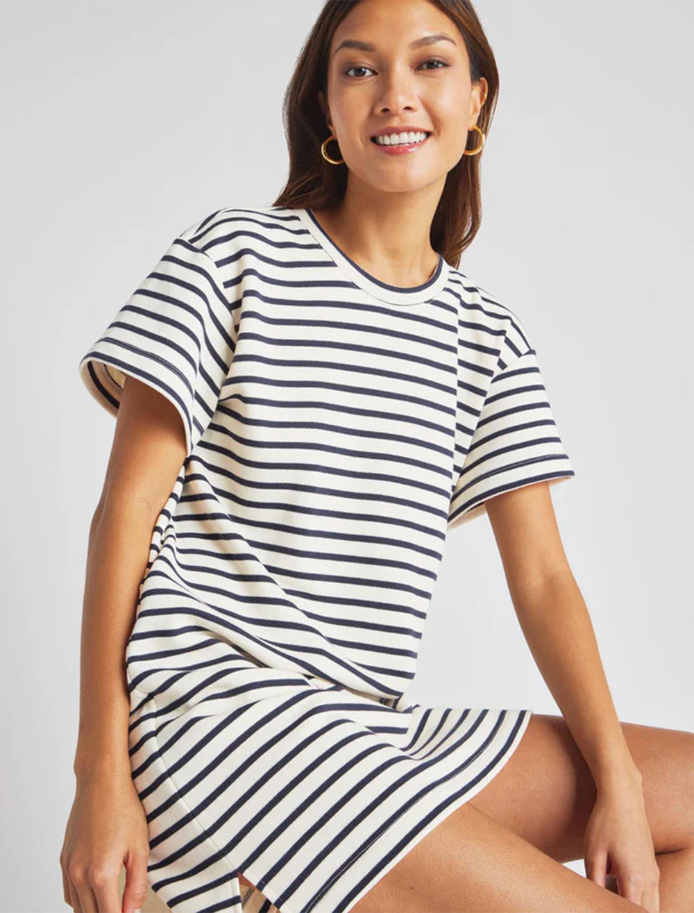 Model wearing Splendid's whitney stripe dress in navy and white.