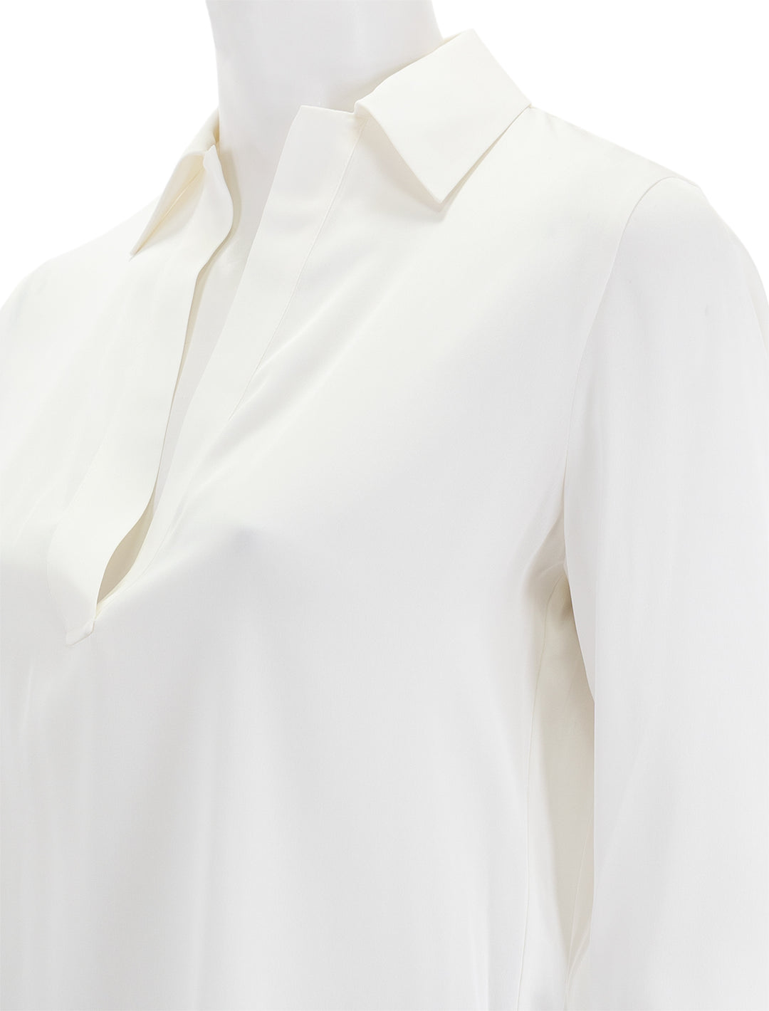 Close-up view of Vince's pullover long sleeve silk polo in off white.