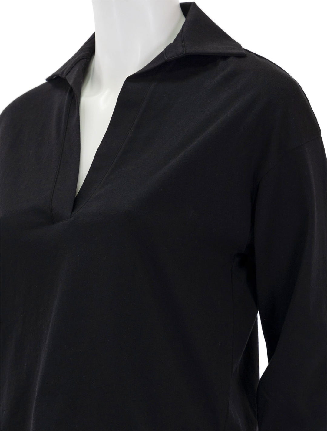Close-up view of Vince's easy long sleeve polo in black.