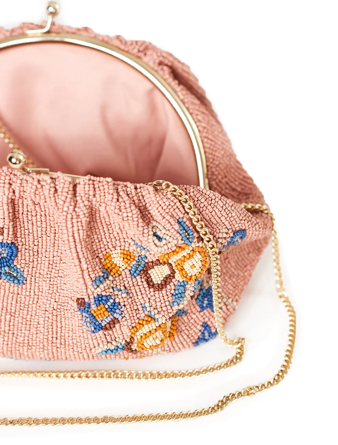 Close-up view of M.A.B.E.'s birdie beaded clutch in dusty pink.