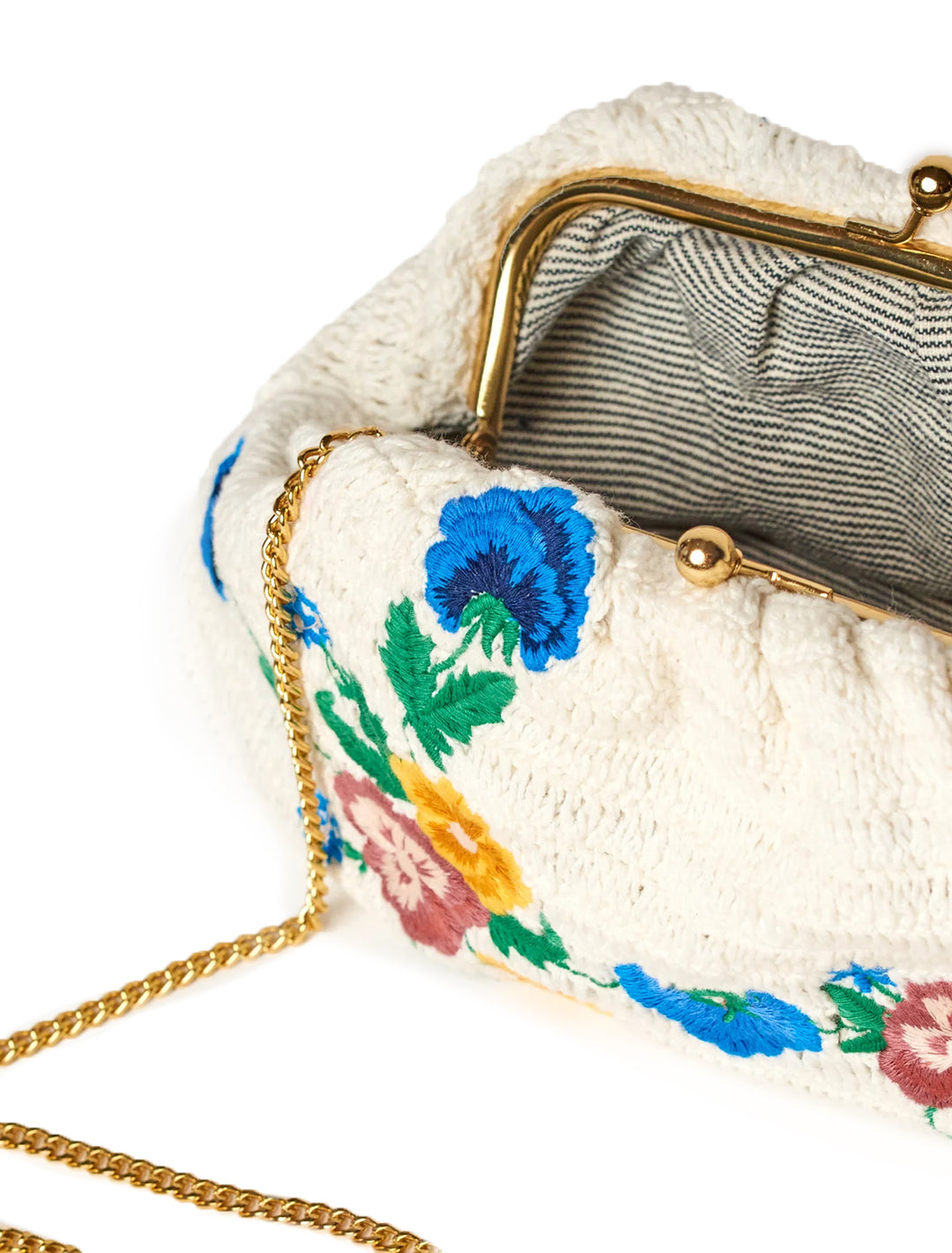 Close-up view of M.A.B.E.'s vela embroidered crochet clutch.