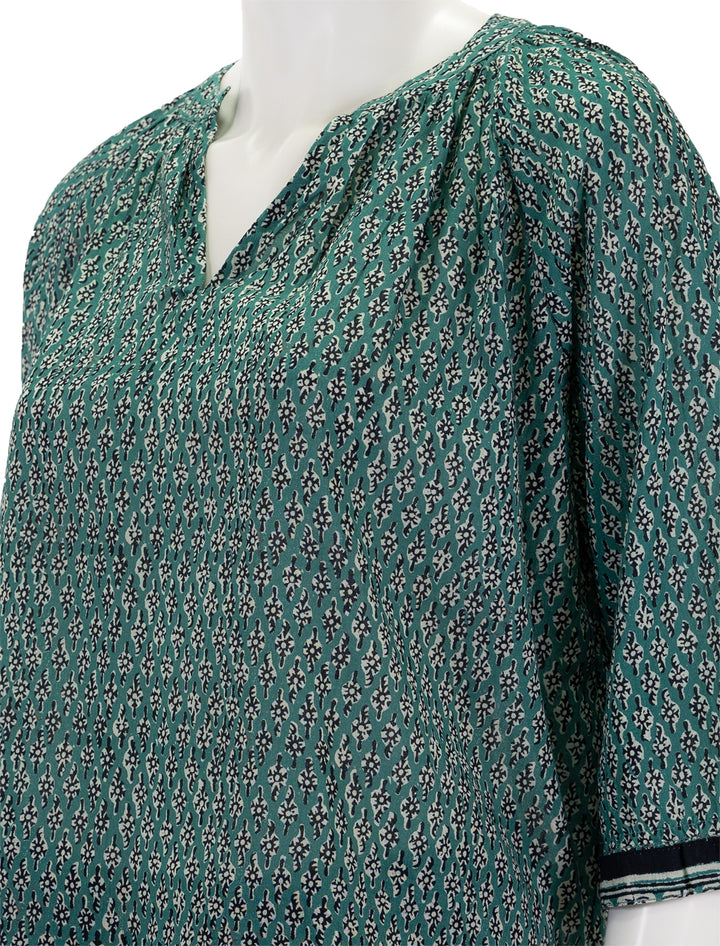 Close-up view of MABE's mari print top in green.