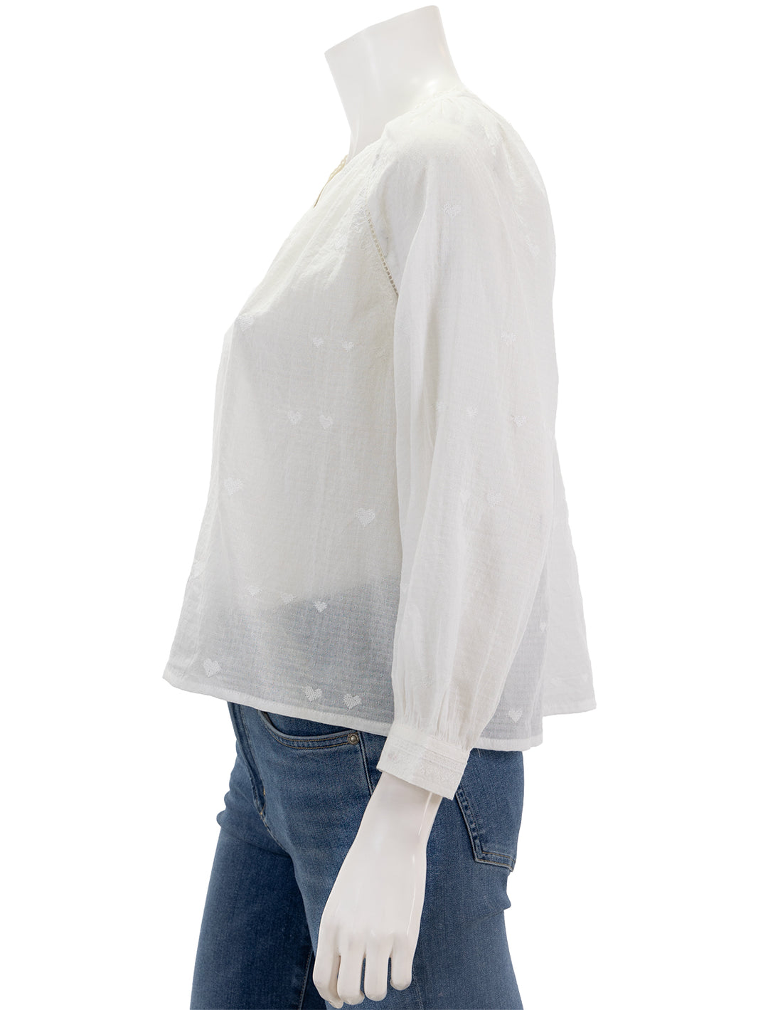 Side view of MABE's elani embroidered heart blouse in white.