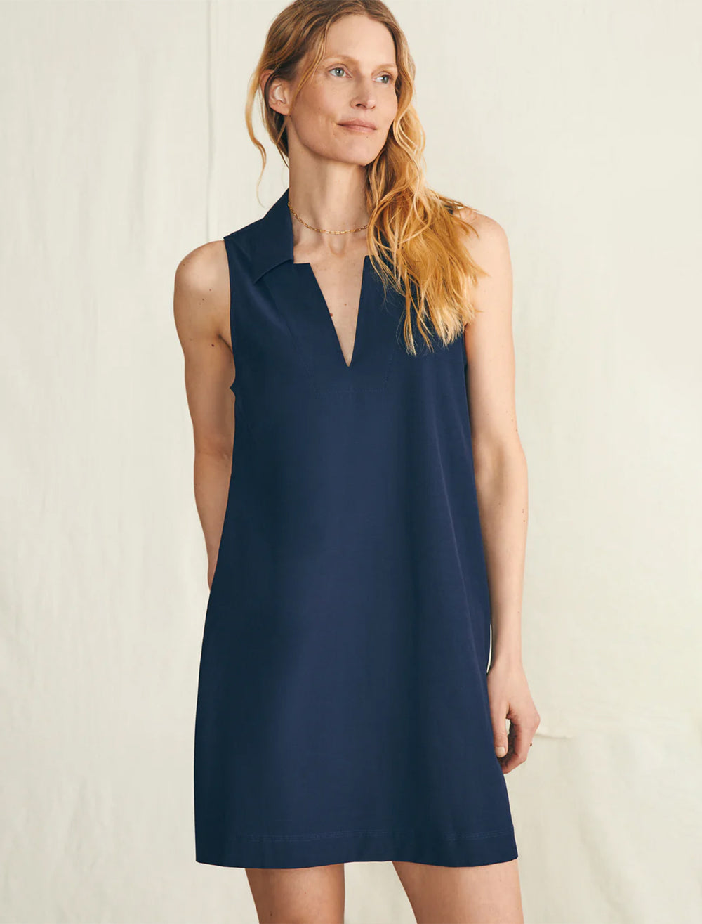 Model wearing Faherty's all day polo dress in navy blazer.
