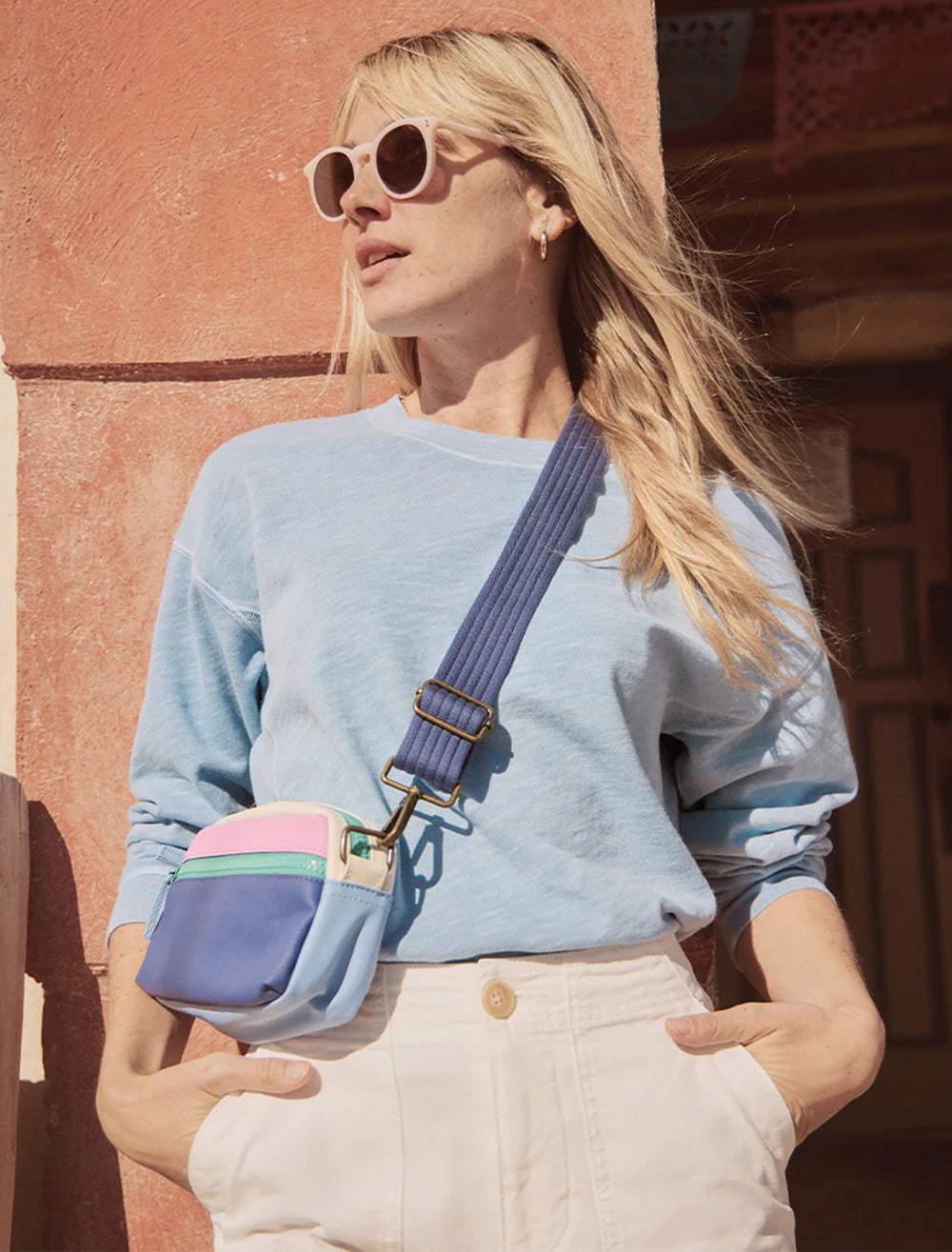 Model wearing Marine Layer's fanny pack in lilac colorblock.