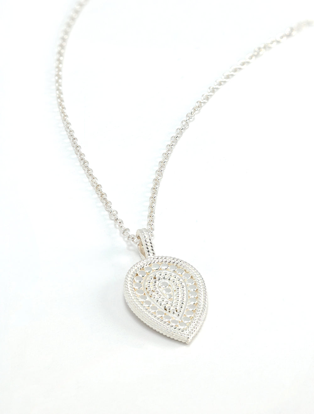 Stylized laydown of Anna Beck's beaded teardrop inverted pendant necklace in silver.