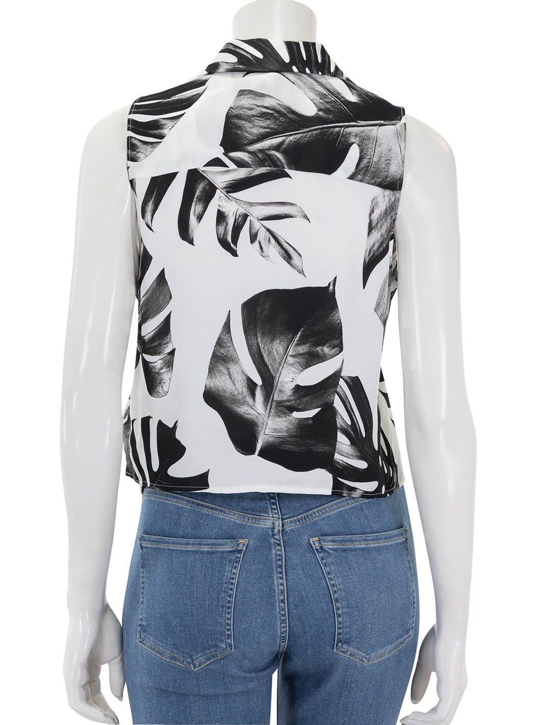 Back view of L'Agence's amos sleeveless tie blouse in black and white palm leaves.