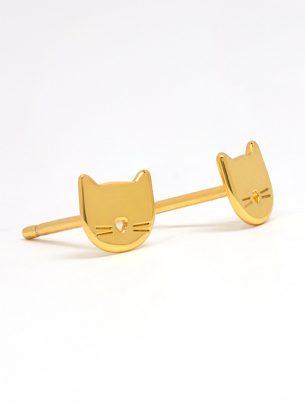 Close-up view of Tai's cat studs in gold.