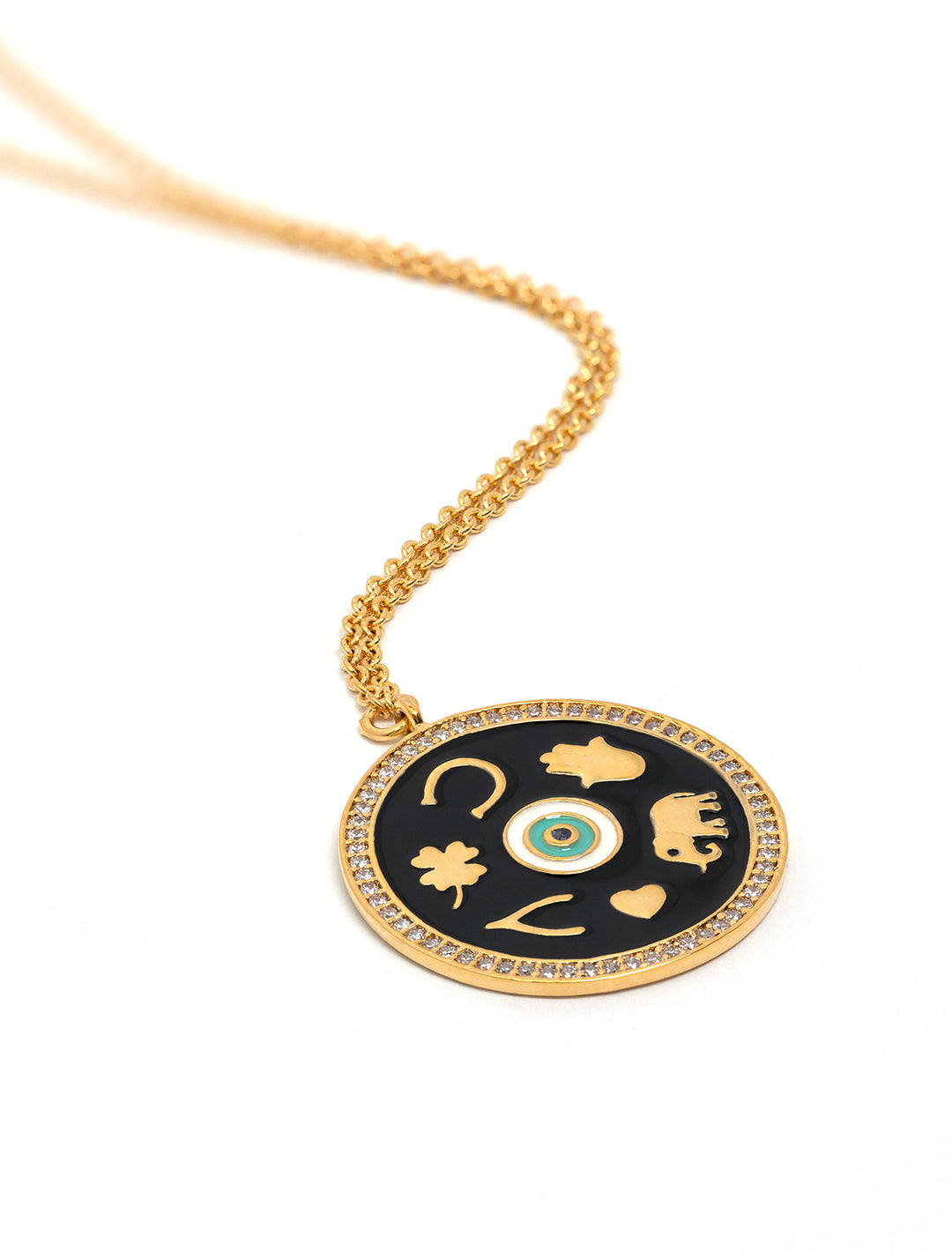Stylized laydown of Tai Jewelry's black enamel luck pendant in gold.