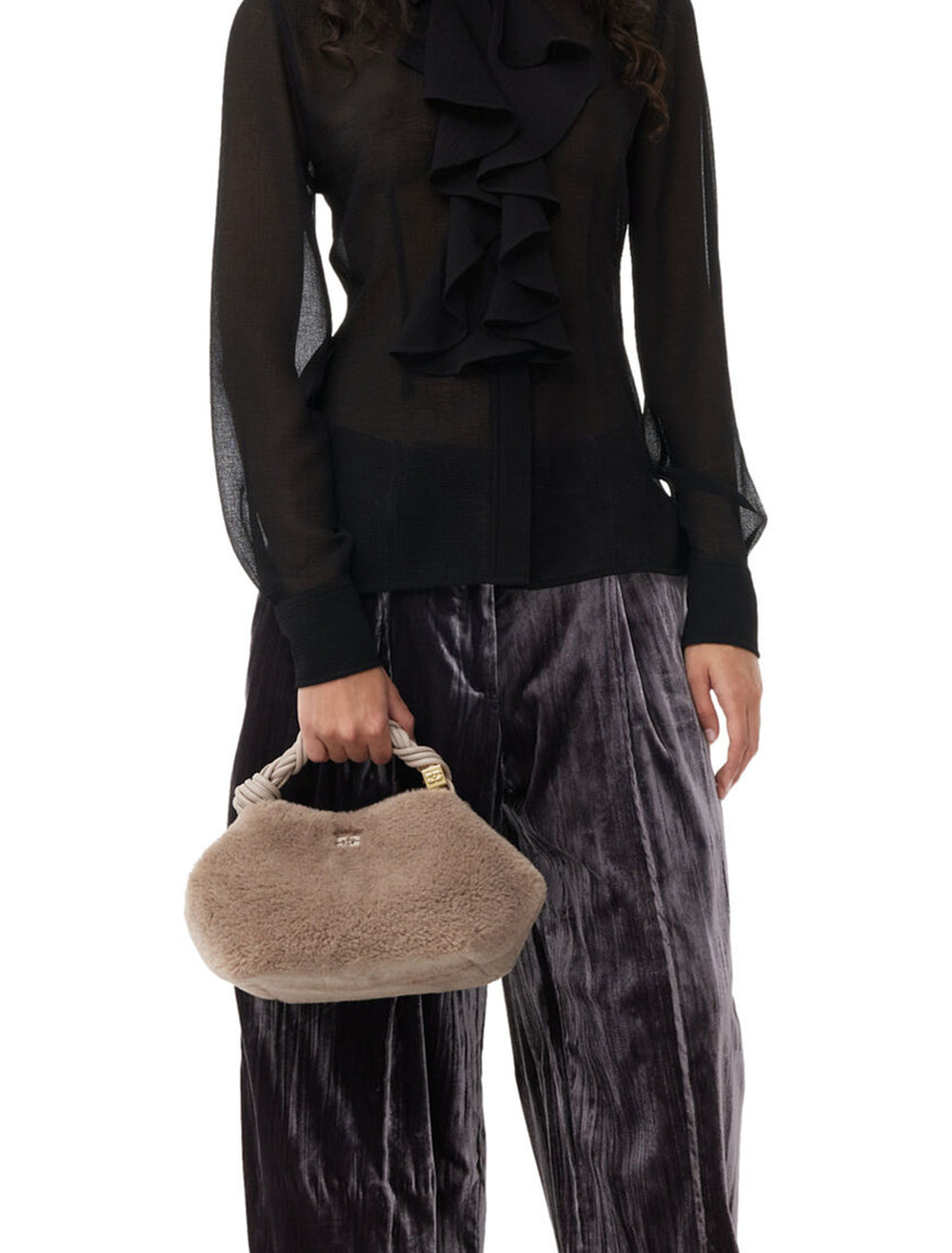 Model holding GANNI's small bou bag in oyster gray fur.