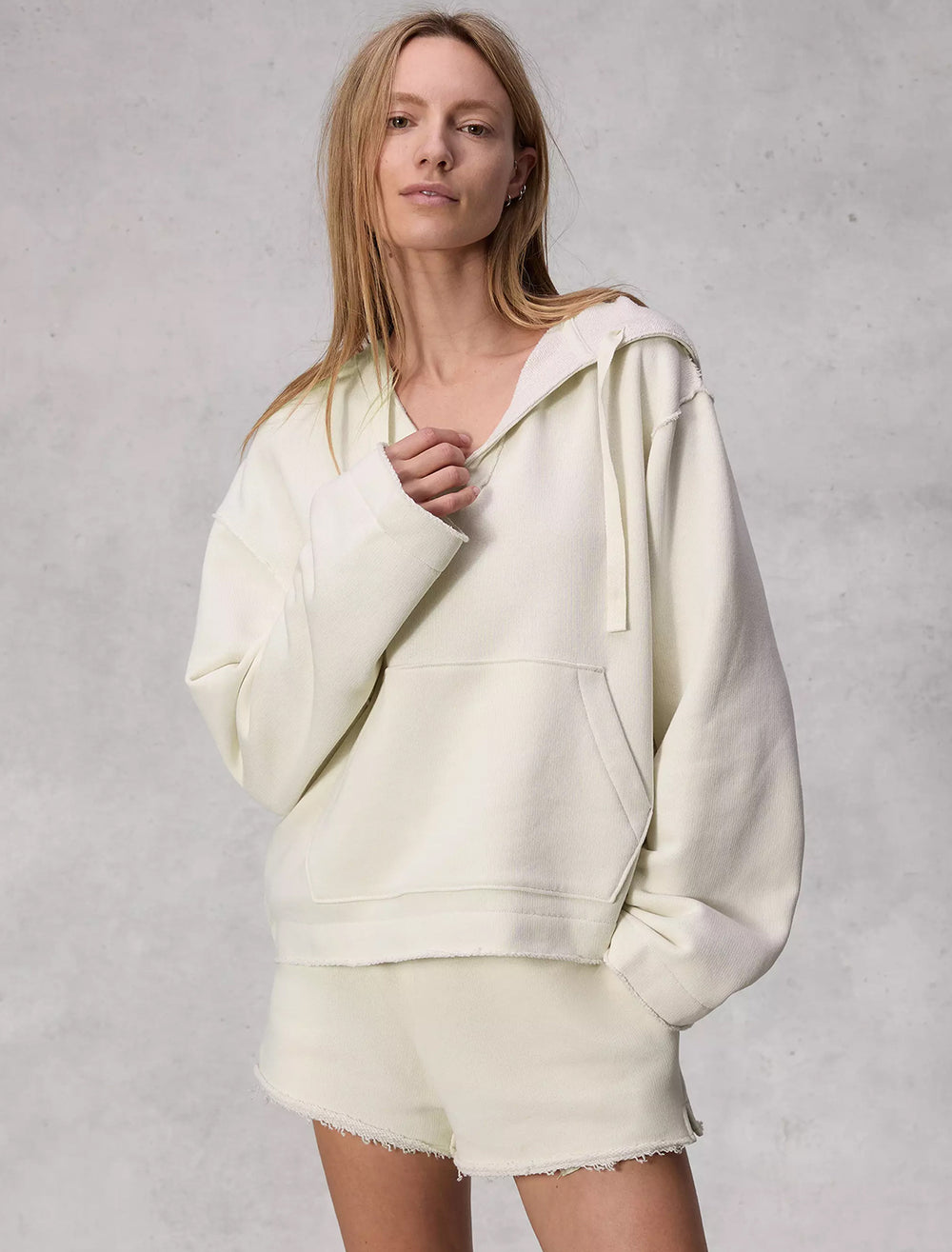 Model wearing Rag & Bone's baja hoodie in offwhite.