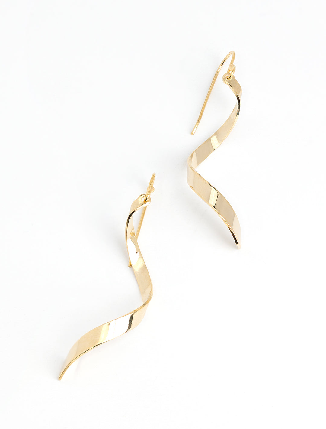 Stylized laydown of AV Max's Gold Ribbon Twist Earrings.
