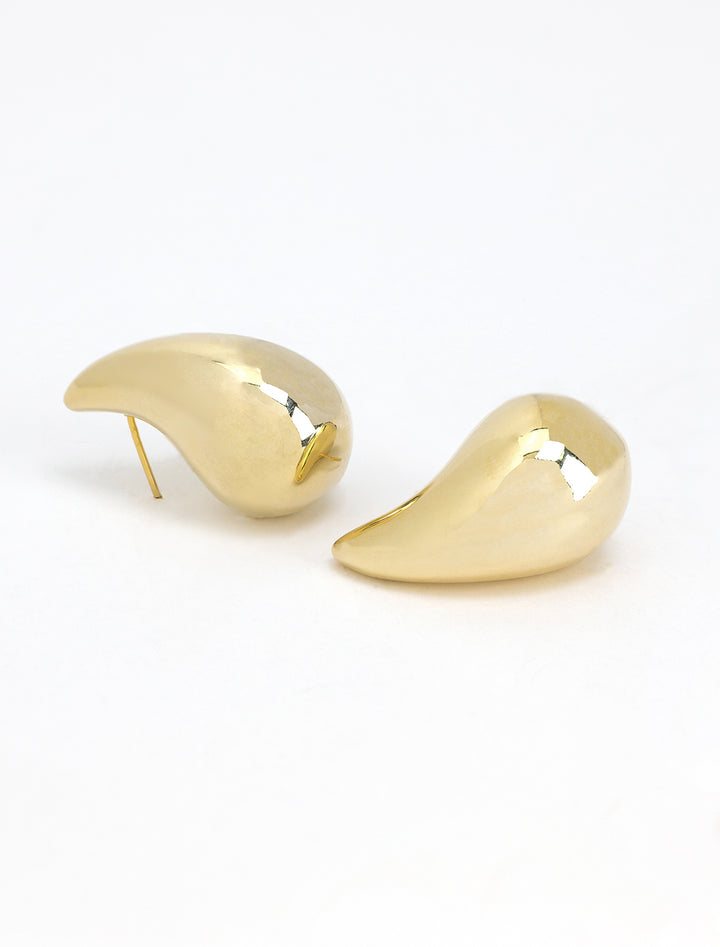 Stylized laydown of AV Max's Large Puff Teardrop Earrings in Gold.