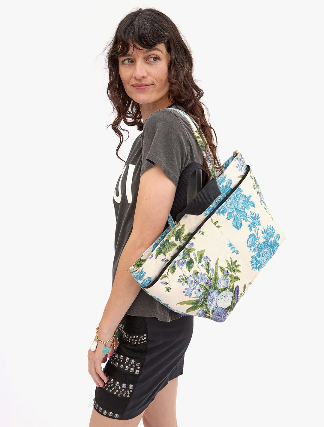 Model carrying Clare V.'s poche bateau in blue floral stripe.