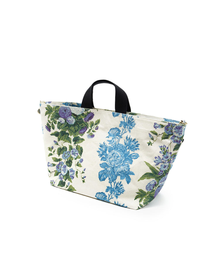 Side angle view of Clare V.'s poche bateau in blue floral stripe.