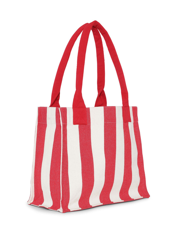 Back angle view of GANNI's large easy shopper in barbados cherry stripe.