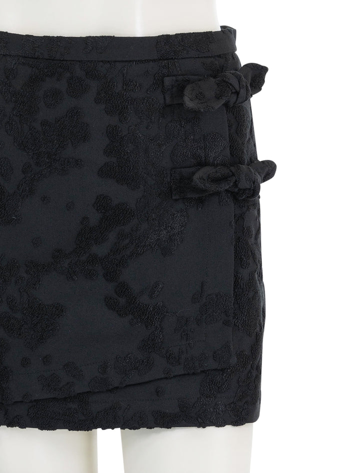 Close-up view of GANNI's boucle jacquard suiting mini skirt.