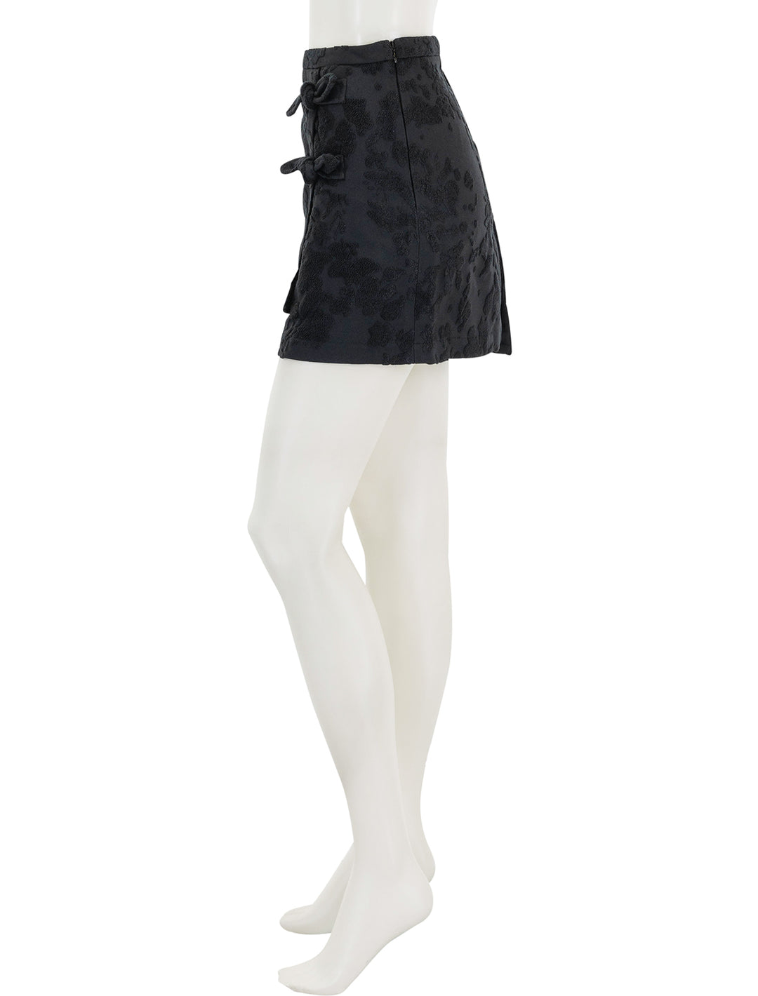 Side view of GANNI's boucle jacquard suiting mini skirt.