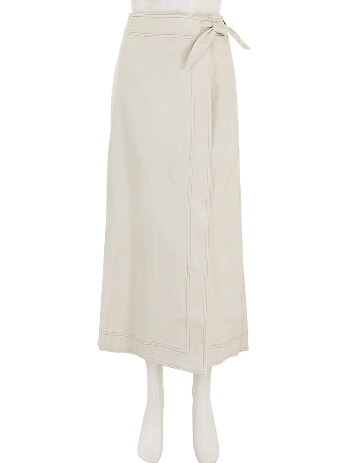 Front view of GANNI's herringbone canvas long wrap skirt in summer sand.