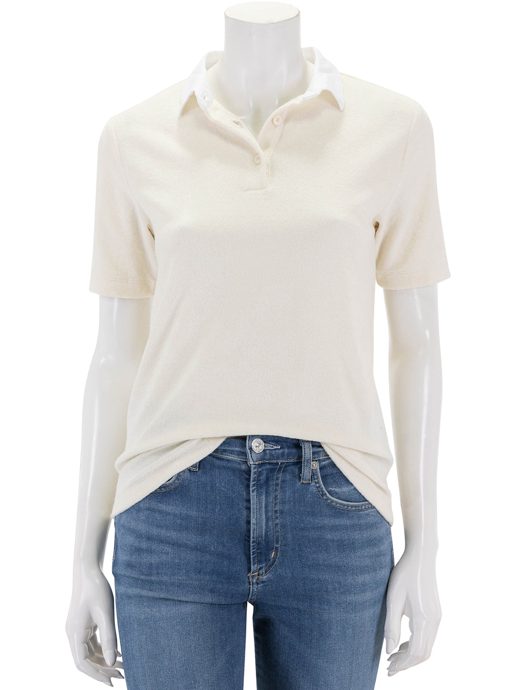 Front view of KULE's the women's terry polo in cream.