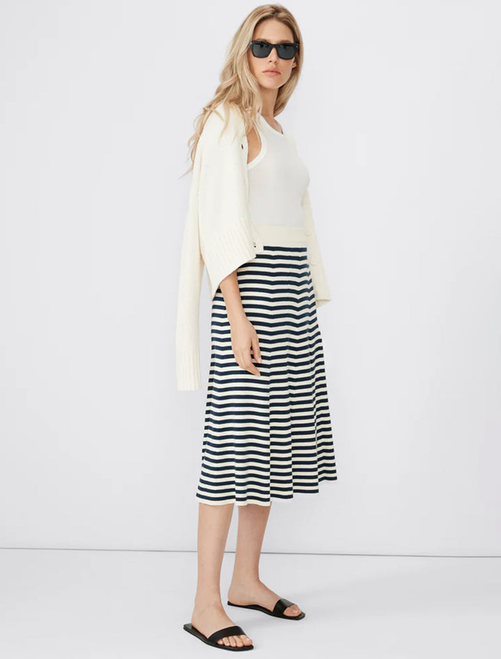 Model wearing KULE's the sabine skirt in cream and navy stripe.